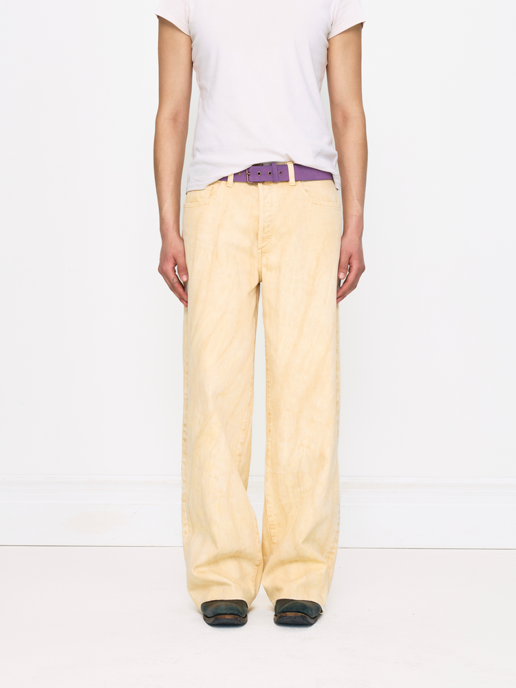 Person wearing light-colored pants and a white shirt on a white background