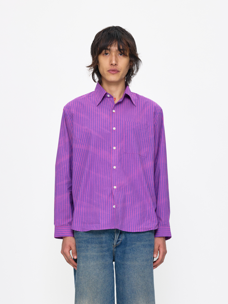 Person wearing a purple striped shirt on a white background