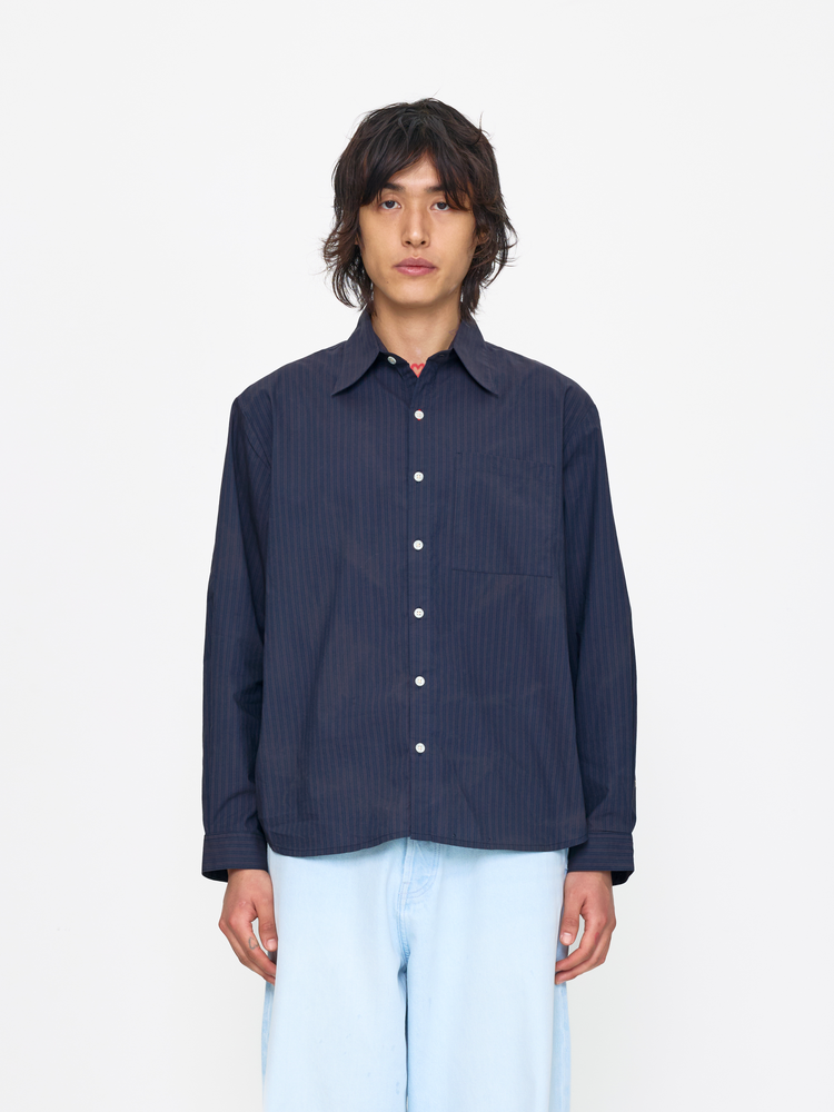 Person wearing a dark blue striped shirt on a white background